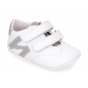 Tennis style shoes for babies with hook and loop strap in soft leather combined with patent leather.