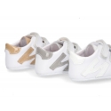 Tennis style shoes for babies with hook and loop strap in soft leather combined with patent leather.