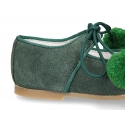 Suede leather little classic Mary jane shoes with POMPONS ties closure.