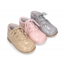 Classic patent leather English style bootie for first steps in pastel colors.