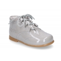 Classic patent leather English style bootie for first steps in pastel colors.