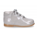 Classic patent leather English style bootie for first steps in pastel colors.