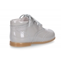 Classic patent leather English style bootie for first steps in pastel colors.