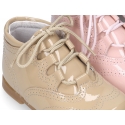 Classic patent leather English style bootie for first steps in pastel colors.