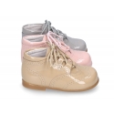 Classic patent leather English style bootie for first steps in pastel colors.