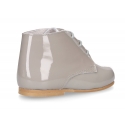 Classic patent leather ankle boots to dress for first steps.