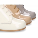 Classic patent leather ankle boots to dress for first steps.