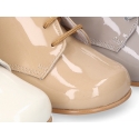 Classic patent leather ankle boots to dress for first steps.