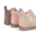 Suede leather little ankle boots with zipper, toe cap and counter for first steps.