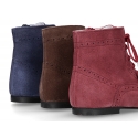 Classic suede leather in dark colors Pascuala styel ankle boots with tassels.