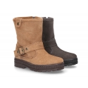 Suede leather boots with buckle design and zipper closure.