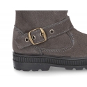 Suede leather boots with buckle design and zipper closure.