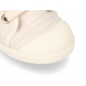 Soft cotton canvas tennis shoes with toe cap.
