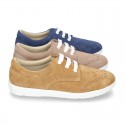 Classic suede leather Laces up shoes tennis style with ties closure and perforated design.