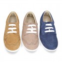 Classic suede leather Laces up shoes tennis style with ties closure and perforated design.