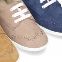 Classic suede leather Laces up shoes tennis style with ties closure and perforated design.