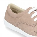 Classic suede leather Laces up shoes tennis style with ties closure and perforated design.