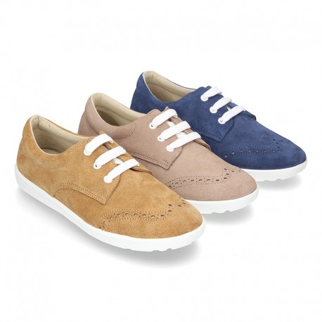 Classic suede leather Laces up shoes tennis style with ties closure and perforated design.