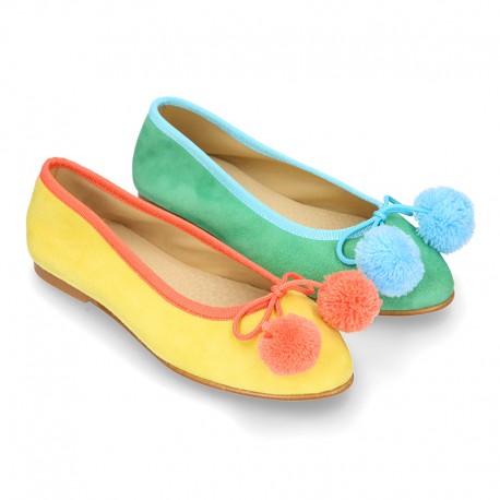 Soft suede leather classic ballet flats with pompons.