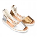 New halter Menorquina sandals in metal leather with crossed ribbons.
