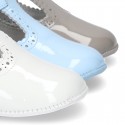 New T-Strap shoes for babies with Velcro strap, button and waves design in patent leather.