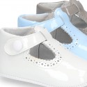 New T-Strap shoes for babies with Velcro strap, button and waves design in patent leather.