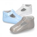 New T-Strap shoes for babies with Velcro strap, button and waves design in patent leather.