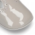 New T-Strap shoes for babies with Velcro strap, button and waves design in patent leather.