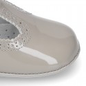 New T-Strap shoes for babies with Velcro strap, button and waves design in patent leather.