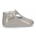 New T-Strap shoes for babies with Velcro strap, button and waves design in patent leather.