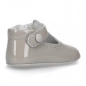 New T-Strap shoes for babies with Velcro strap, button and waves design in patent leather.