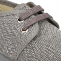 Wash effect cotton canvas laces up shoes for kids.