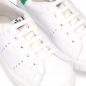 New trendy casual tennis shoes with green counter.