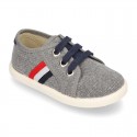 New WASHED EFFECT canvas tennis style shoes with flag detail.