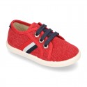 New WASHED EFFECT canvas tennis style shoes with flag detail.