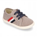 New WASHED EFFECT canvas tennis style shoes with flag detail.