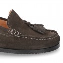 Classic suede leather moccasins with tassels and thick soles.