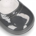 Classic little Mary Janes with chopped design in patent leather.