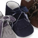 Suede leather little bootie for babies with velvet ties closure and fringed design.