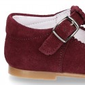 Classic Suede leather T-strap shoes with scallop and buckle fastening.