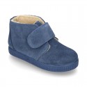 New suede leather little bootie sneaker style with fake hair lining and velcro strap.