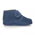 New suede leather little bootie sneaker style with fake hair lining and velcro strap.