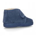 New suede leather little bootie sneaker style with fake hair lining and velcro strap.