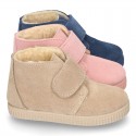 New suede leather little bootie sneaker style with fake hair lining and velcro strap.