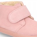 New suede leather little bootie sneaker style with fake hair lining and velcro strap.