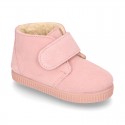 New suede leather little bootie sneaker style with fake hair lining and velcro strap.