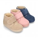 New suede leather little bootie sneaker style with fake hair lining and velcro strap.