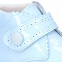 Little ankle boots for babies with velcro strap closure in patent leather.