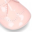 Little ankle boots for babies with velcro strap closure in patent leather.