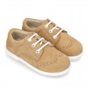 Classic suede leather Laces up shoes with ties closure and perforated design.